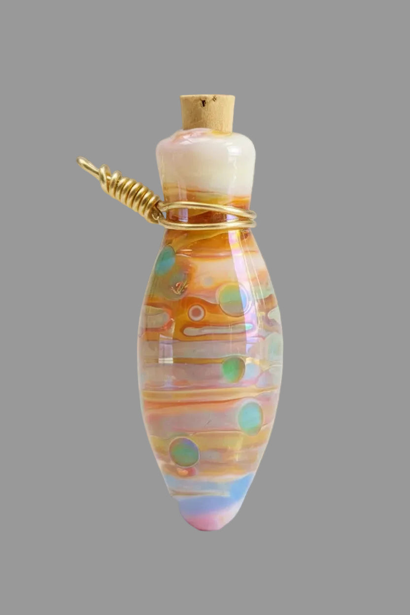 A small decorative glass bottle pendant with a gold-tone cap and wire wrap, featuring multicolored iridescent bands on a black textured background.