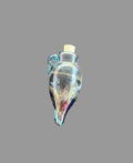 A small hand-blown glass bottle pendant with a cork stopper, featuring swirls of blue, gold, and red glass, resting on a dark textured surface.