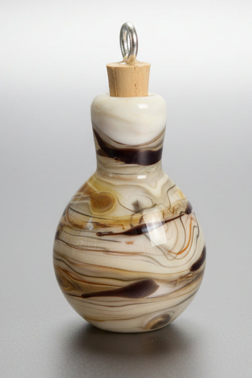 A small decorative glass bottle with a cork stopper, featuring a marbled swirl pattern in cream, brown, and black.
